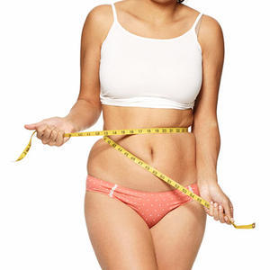 Overweight girl measuring waist